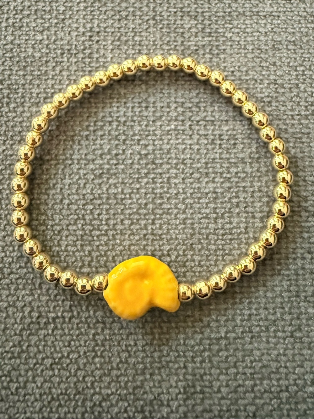 Gold Beaded Stretch Bracelet with Yellow Ceramic Shell Charm
